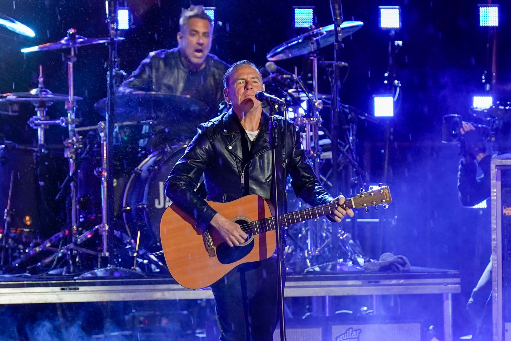 Uninvited Fan Interrupts Bryan Adams Mid-Performance For a Duet of 'Summer of 69' [WATCH]