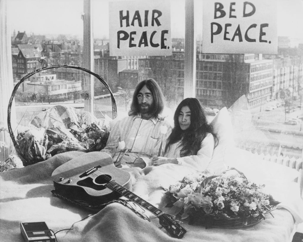 John Lennon and Yoko Ono lay in their bed in the Presidential Suite of the Hilton Hotel, Amsterdam, 25th March 1969. The couple are staging a 'bed-in for peace' and intend to stay in bed for seven days 'as a protest against war and violence in the world.'