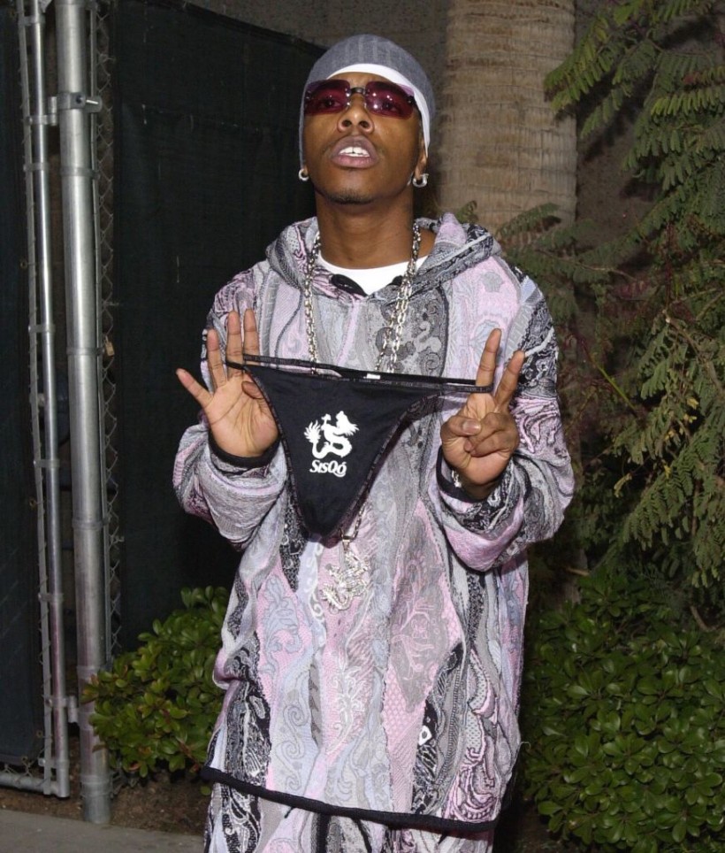 SisQó poses with some of his signature merch.