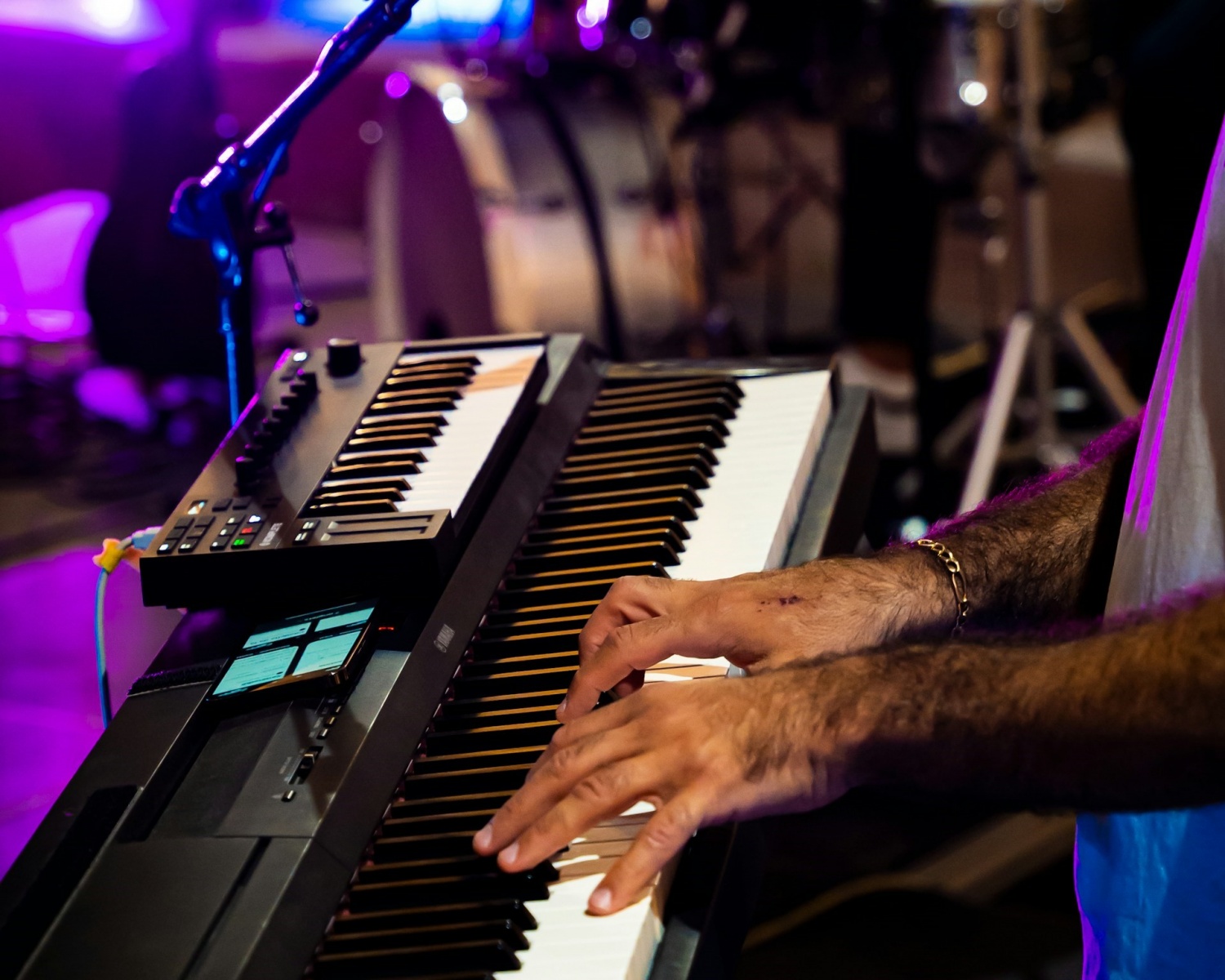 Man playing piano / synthesizer at a concert