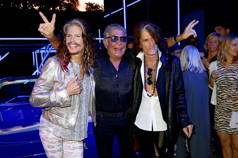Aerosmith's Steven Tyler and Joe Perry flank designer Roberto Cavalli at Milan Fashion Week in 2014.