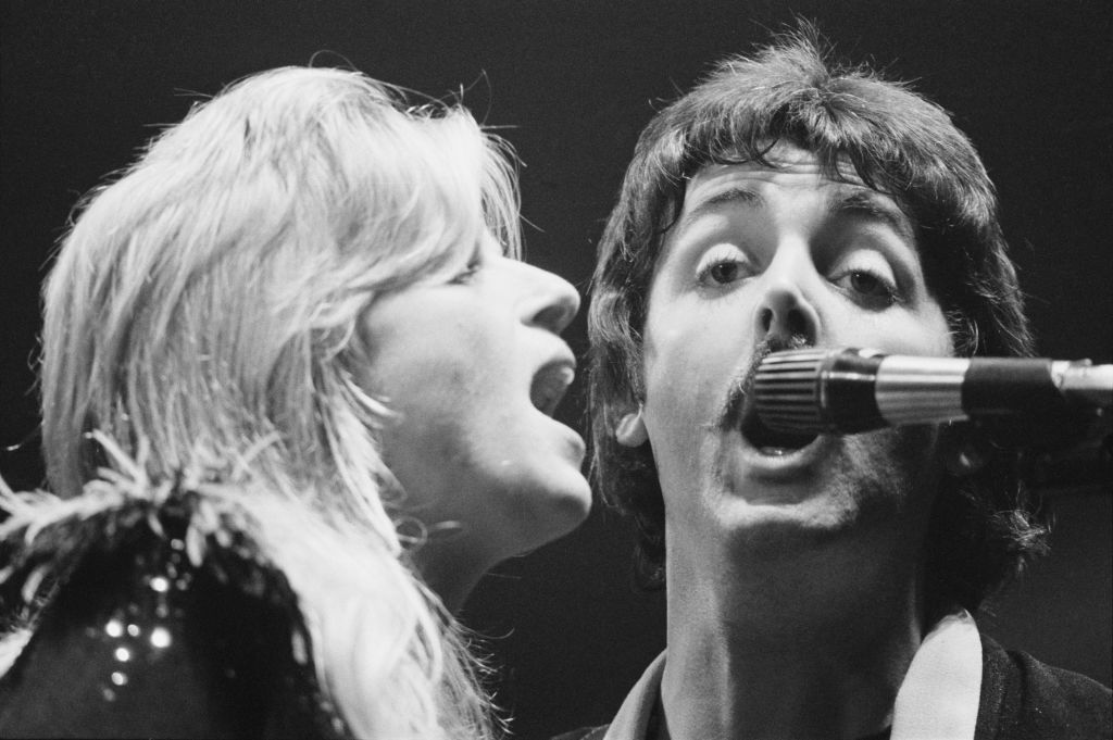 Paul McCartney and his wife, Linda McCartney, perform with the Wings during their 'Wings Over the World tour' at the Hammersmith Odeon, London, UK, October 1976.