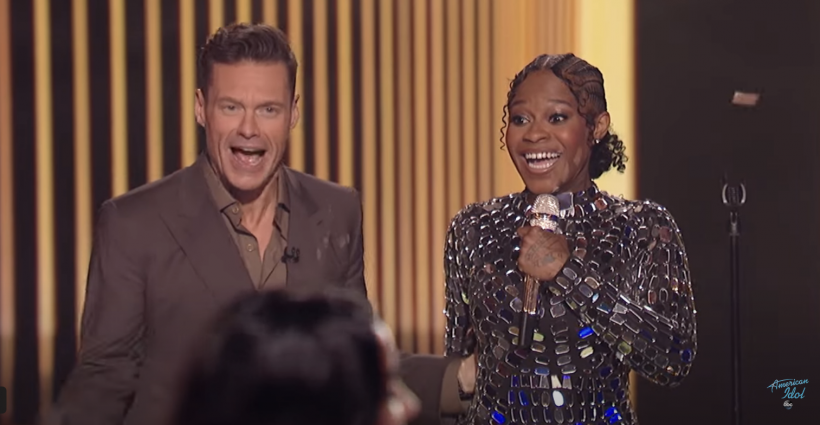 Ryan Seacrest announces Just Sam's win on the 'American Idol' stage, four years after she won remotely from her hotel room.