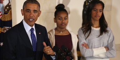 President Obama speaks as his daughters Sasha and Malia look on before pardoning national Thanksgiving Turkey at annual ceremony.