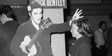 Elvis puts a spell, probably Satanic, on a young fan. 
