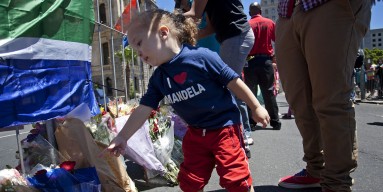 A child pays homage to Nelson Mandela