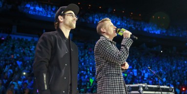 Macklemore (R) and Ryan Lewis speak onstage at We Day at Rogers Arena on October 22, 2014