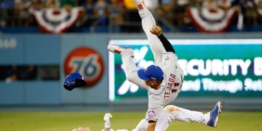 Ruben Tejada #11 of the New York Mets is hit by a slide by Chase Utley #26 of the Los Angeles Dodgers in the seventh inning in an attempt to turn a double play in game two of the National League Division Series at Dodger Stadium on October 10, 2015 in Los