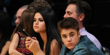 Justin Bieber and girlfriend Selena Gomez watch the game between the San Antonio Spurs and the Los Angeles Lakers at Staples Center on April 17, 2012 in Los Angeles, California.