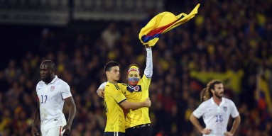 A Colombia fan runs onto the pitch to greet Captain James Rodriguez during the International Friendly between the USA and Colombia at Craven Cottage on November 14, 2014 in London, England. 