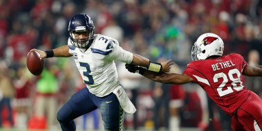 Quarterback Russell Wilson #3 of the Seattle Seahawks scrambles with the football during the NFL game against the Arizona Cardinals at the University of Phoenix Stadium on December 21, 2014 in Glendale, Arizona. The Seahawks defeated the Cardinals 35-6. 