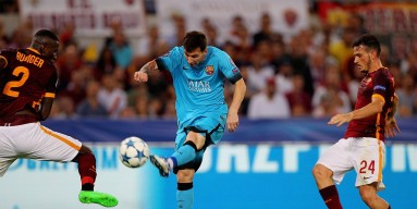 Lionel Messi (C) of FC Barcelona kicks the ball during the UEFA Champions League Group E match between AS Roma and FC Barcelona at Stadio Olimpico on September 16, 2015 in Rome, Italy. 
