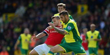 Jack Wilshere of Arsenal battles with Bradley Johnson of Norwich City during the Barclays Premier League match between Norwich City and Arsenal at Carrow Road on May 11, 2014 in Norwich, England.
