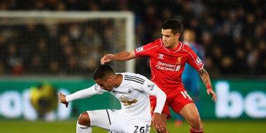 Kyle Naughton of Swansea City is closed down by Philippe Coutinho of Liverpool during the Barclays Premier League match between Swansea City and Liverpool at Liberty Stadium on March 16, 2015 in Swansea, Wales. 