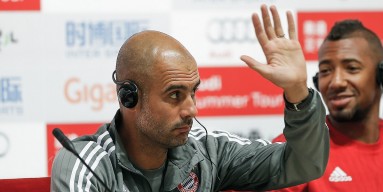 Head coach Pep Guardiola of Bayern gestures with Jerome Boateng during the a press conference at National Stadium in day 1 of the FC Bayern Audi China Summer Pre-Season Tour on July 17, 2015 in Beijing, China. 