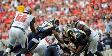Josh McCown #12 of the Tampa Bay Buccaneers is sacked during the first half of the game against the St. Louis Rams at Raymond James Stadium on September 14, 2014 in Tampa, Florida. 