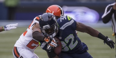 Running back Christine Michael #32 of the Seattle Seahawks runs with the ball as defensive back Tramon Williams #22 of the Cleveland Browns tries to make the tackle during the first half of a football game at CenturyLink Field on December 20, 2015 in Seat