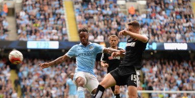 Raheem Sterling of Manchester City is tackled by Craig Cathcart of Watford during the Barclays Premier League match between Manchester City and Watford at the Etihad Stadium on August 29, 2015 in Manchester, United Kingdom. 