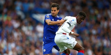 Wilfried Zaha of Crystal Palace and Sesc Fabregas of Chelsea compete for the ball during the Barclays Premier League match between Chelsea and Crystal Palace at Stamford Bridge on August 29, 2015 in London, England. 
