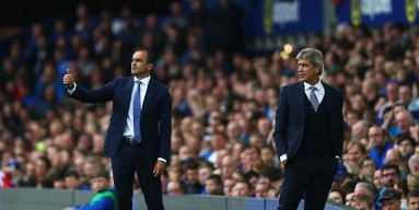 Roberto Martinez, manager of Everton gives instructions with Manuel Pellegrini, manager of Manchester City during the Barclays Premier League match between Everton and Manchester City at Goodison Park on August 23, 2015 in Liverpool, England. 