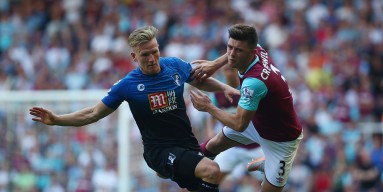 Aaron Cresswell of West Ham United and Matt Ritchie of Bournemouth compete for the ball during the Barclays Premier League match between West Ham United and A.F.C. Bournemouth at the Boleyn Ground on August 22, 2015 in London, England.