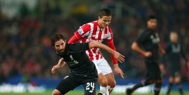 Joe Allen of Liverpool and Ibrahim Afellay of Stoke City compete for the ball during the Capital One Cup semi final, first leg match between Stoke City and Liverpool at the Britannia Stadium on January 5, 2016 in Stoke on Trent, England. 