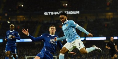  Raheem Sterling of Manchester City is challenged by John Stones of Everton during the Barclays Premier League match between Manchester City and Everton at the Etihad Stadium on January 13, 2016 in Manchester, England. 