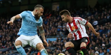 Fabio Borini of Sunderland is challenged by Nicolas Otamendi of Manchester City during the Barclays Premier League match between Manchester City and Sunderland at the Etihad Stadium on December 26, 2015 in Manchester, England. 