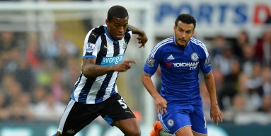 Georginio Wijnaldum of Newcastle United under pressure from Pedro of Chelsea during the Barclays Premier League match between Newcastle United and Chelsea at St James' Park on September 26, 2015 in Newcastle upon Tyne, United Kingdom.
