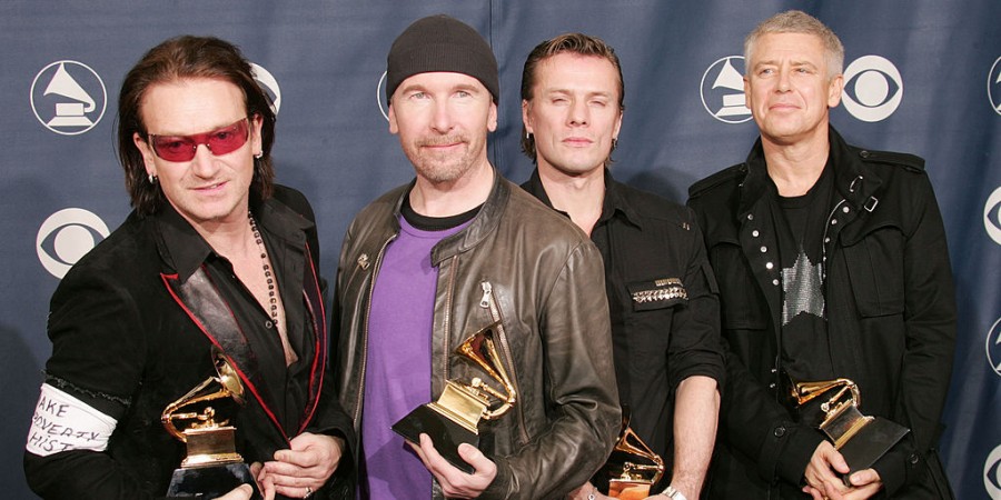 Bono (L-R), The Edge, Larry Mullen, and Adam Clayton of U2 pose with their award for Best Rock Performance by a Group backstage during the 47th Annual Grammy Awards at the Staples Center February 13, 2005 in Los Angeles.