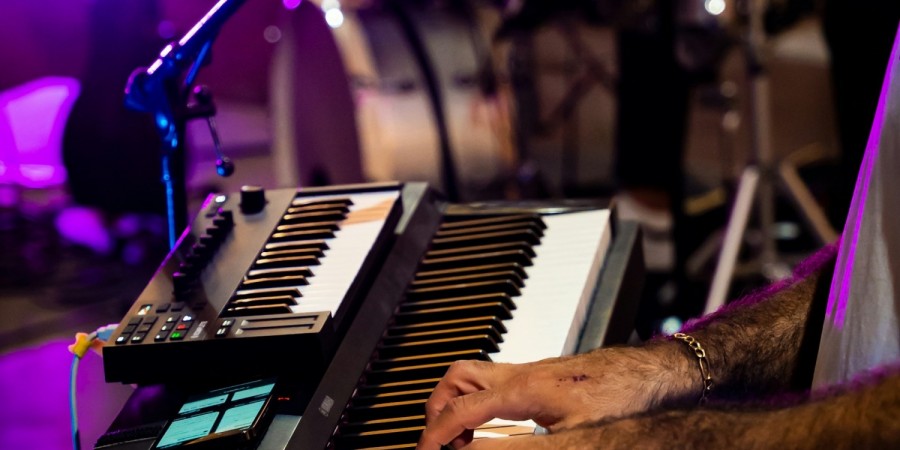 Man playing piano / synthesizer at a concert