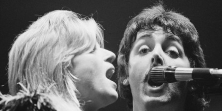Paul McCartney and his wife, Linda McCartney, perform with the Wings during their 'Wings Over the World tour' at the Hammersmith Odeon, London, UK, October 1976.