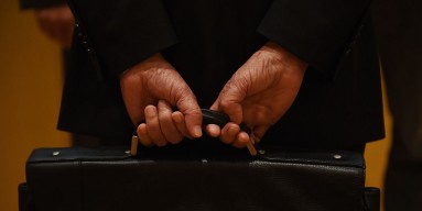 A lawyer holding his briefcase