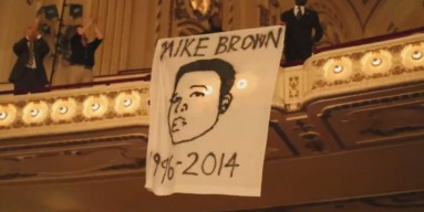 Mike Brown demonstrators interrupted a performance by the St. Louis Symphony to sing a requiem for the teen as tensions grow over the police shooting of the unarmed 18-year-old. 